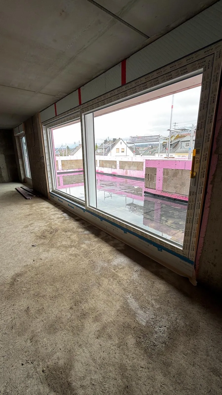 Blick von innen durch die eingebaute Weru-Hebeschiebetür ins Freie, Neubau im Rohbau